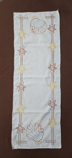 a table cloth with an embroidered design on it