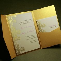 the inside of a gold and white wedding card with an ornate design on it's side