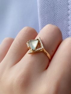 This is a unique piece of design. The artist incorporated the triangular shapes for the jade statement ring. The special cut of jade as well as the contemporary design made this ring a special find. The icy jade is set in 18k yellow gold and surrounded with 24 tiny diamonds. Icy Jade Engagement Ring, Jade Engagement Ring, 18k Gold Engagement Ring, Triangle Ring, Green Stone Rings, Light Weight Jewelry, Coral Ring, Cabochon Ring, Tiny Diamond