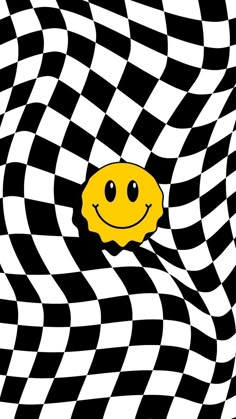 a smiley face is peeking out from the black and white checkered background