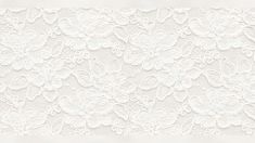 a white lace background with flowers and leaves