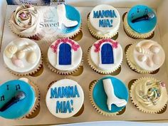 cupcakes decorated with blue and white frosting in a box