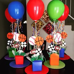 a table topped with lots of colorful balloons