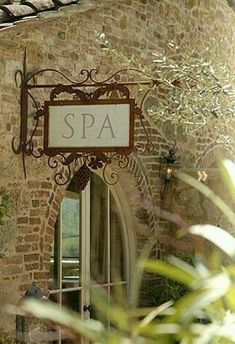 an old building with a sign that says spa on it's front door and window