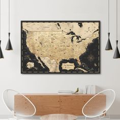 a map of the united states hanging on a wall above a dining room table with chairs