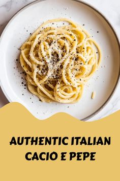 a white plate topped with pasta covered in cheese and seasoning next to a cup of coffee