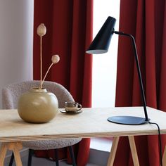 a table with a lamp and a vase on it