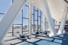 the interior of an office building with large windows and blue carpeted flooring in front of it