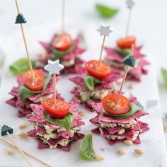 small appetizers with tomatoes, lettuce and other toppings on them