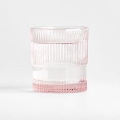 a pink glass vase sitting on top of a white table