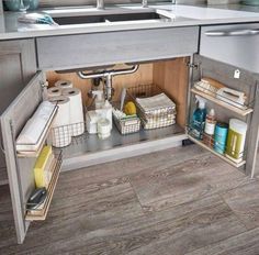 an open cabinet in the middle of a kitchen