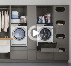 a washer and dryer in a room next to some shelves with towels on them