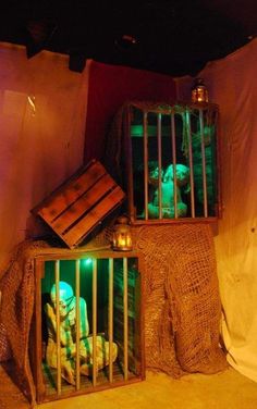 two wooden crates filled with green lights inside of a room next to a white sheet covered wall