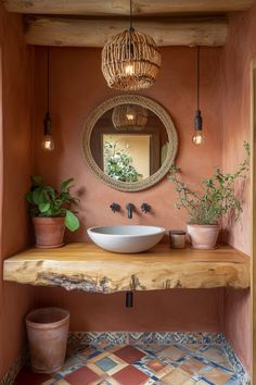 a bathroom with a sink, mirror and potted plants on the counter in front of it