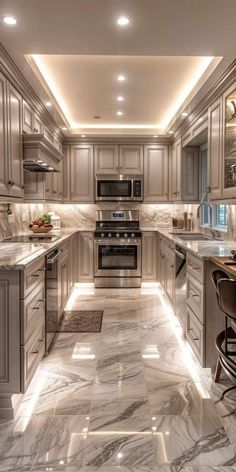 a large kitchen with marble floors and white cabinets