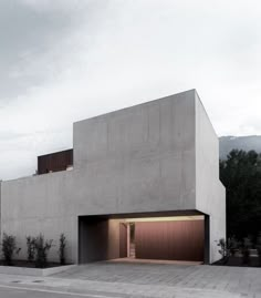 a concrete building with two garages on the side and one door open to let in light