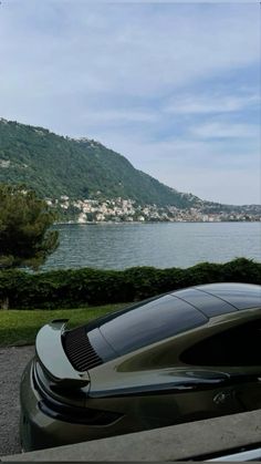 a car parked on the side of a road next to a large body of water