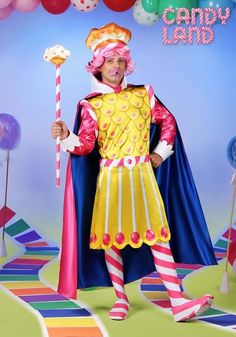 a man dressed up as a clown holding a candy cane in front of balloons and streamers