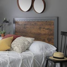 a bed with two mirrors on the wall above it