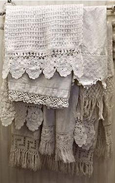 white crocheted curtains hanging on the side of a door with lace and tassels