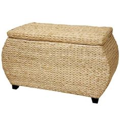 a large wicker ottoman with black legs and a lid on it's side