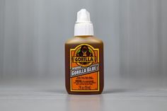 a bottle of gorilla glue sitting on top of a white countertop next to a gray wall