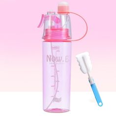 a pink water bottle with a toothbrush next to it