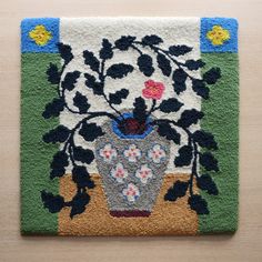 a rug with a flower vase on it