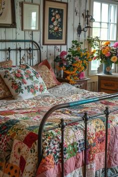 a bed sitting in a bedroom next to a window with lots of flowers on it