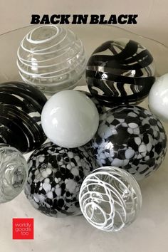 black and white vases sitting on top of a glass table