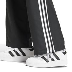 Wide legs make for comfortable days... The adidas Wide Leg Women's Cargo Pants give you plenty of room to move, along with handy cargo pockets to store your belongings. And with the iconic adidas stripes down the side, you can get the comfort and classic style the brand is known for.Features adidas three-stripe design. Relaxed fit. Elastic waistband. Features two cargo pockets. Material: 100% Polyester. Consists of at least 40% recycled materials. Contains 50% Parley Ocean Plastic. Women's Cargo Pants, Adidas Three Stripes, Back To School Backpacks, Adidas Tee, Black And White Sneakers, Move Along, Cargo Pants Women, Cargo Pant, Nike Tees