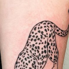 a black and white drawing of a cheetah on the side of a woman's leg