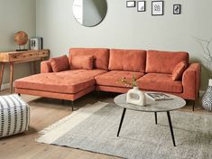 a living room with an orange sectional couch