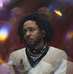 a man with dreadlocks wearing a white shirt