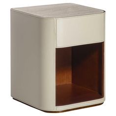 a white and brown cube shaped cabinet with leather linings on the front, two shelves at the top