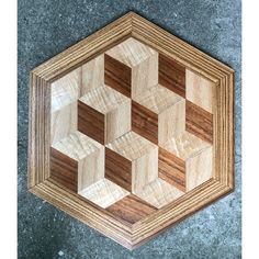 an image of a wooden cutting board on the ground with wood squares cut into hexagonal shapes