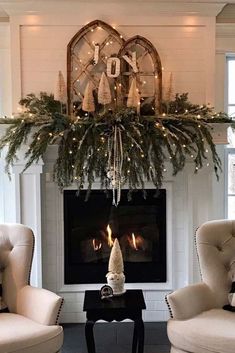 a living room with two chairs and a fire place in front of a christmas tree