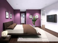 a bed room with a neatly made bed and purple walls