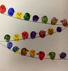 the colorful birds are sitting on the wire