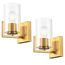 two lights that are next to each other on a wall mounted light fixture, one is gold and the other is clear