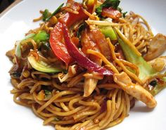 a white plate topped with noodles and veggies