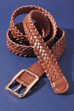 a braided belt on a blue surface