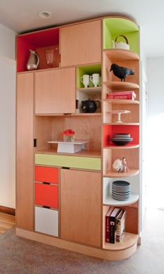 a kitchen with wooden cabinets and colorful shelves