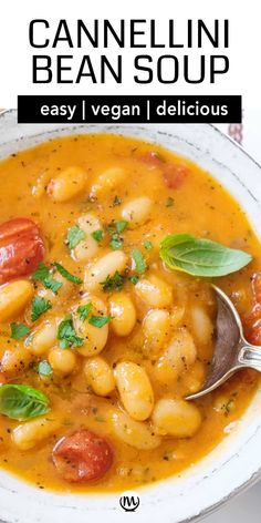 a white bowl filled with bean soup and garnished with fresh basil on top