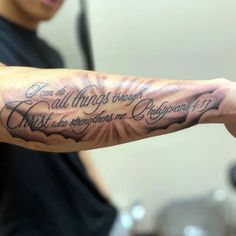 a man with a tattoo on his arm saying i am all things through my eyes