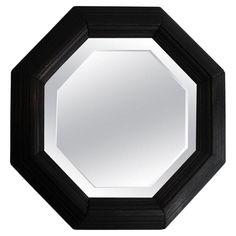 a black and white octagonal mirror on a wall