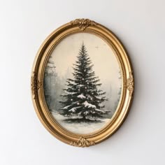 a painting of a christmas tree in a gold frame on a white wall behind it