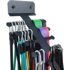 a rack with several different colored umbrellas hanging from it's hooks and straps