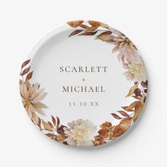 a personalized wedding plate with flowers and leaves on the front, is shown in white