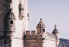 an old stone building with two towers on top